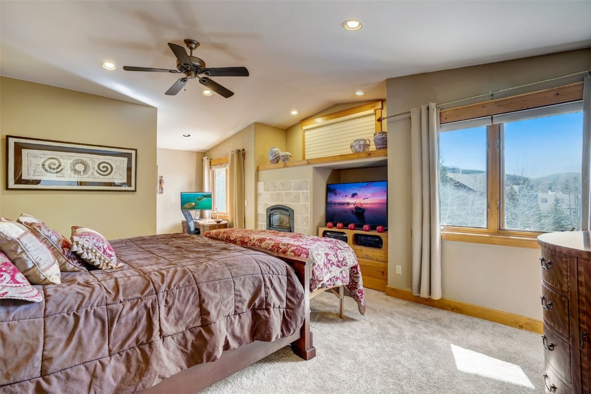 145 Gold Run Circle Dillon, CO 80435 - Photo 13 of 50 a bedroom with a bed and a chandelier