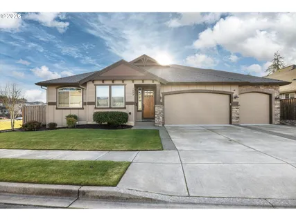 a front view of a house with a yard and garage