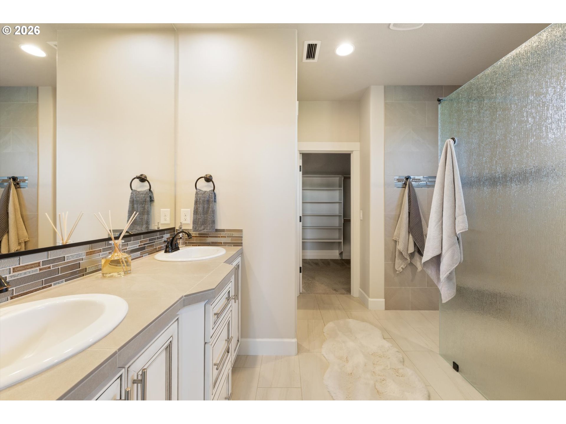 1889 South Harrier Road Ridgefield, WA 98642 - Photo 17 of 29 a bathroom with a double vanity sink a mirror and a shower
