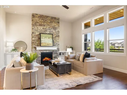 a living room with furniture a fireplace and a potted plant
