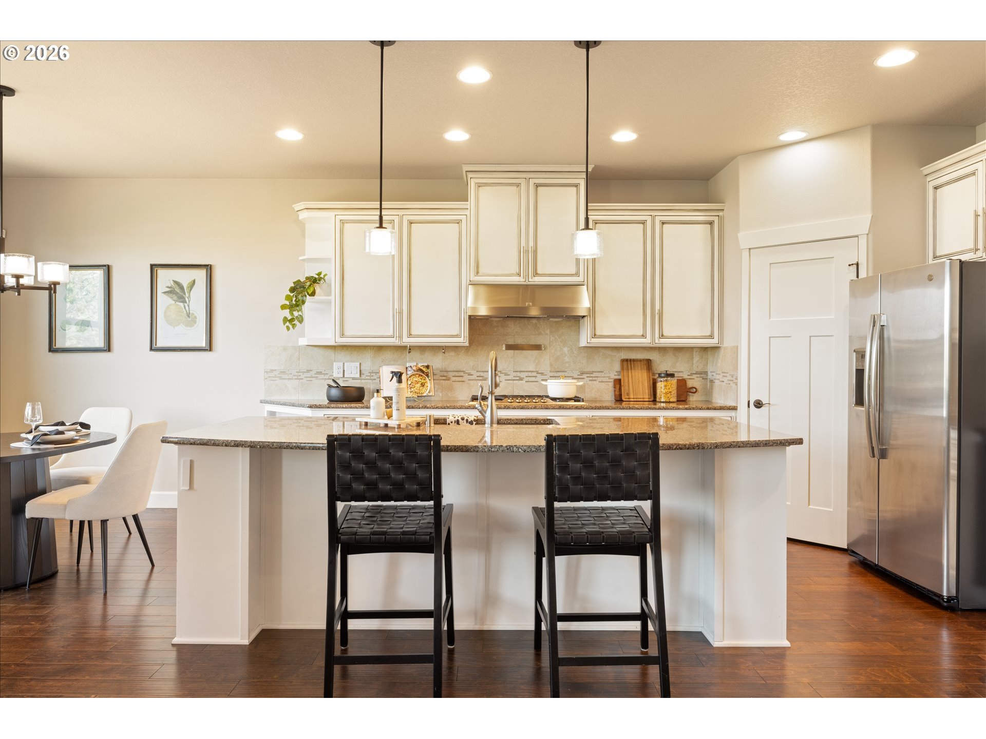 1889 South Harrier Road Ridgefield, WA 98642 - Photo 9 of 29 a kitchen with refrigerator a sink and chairs