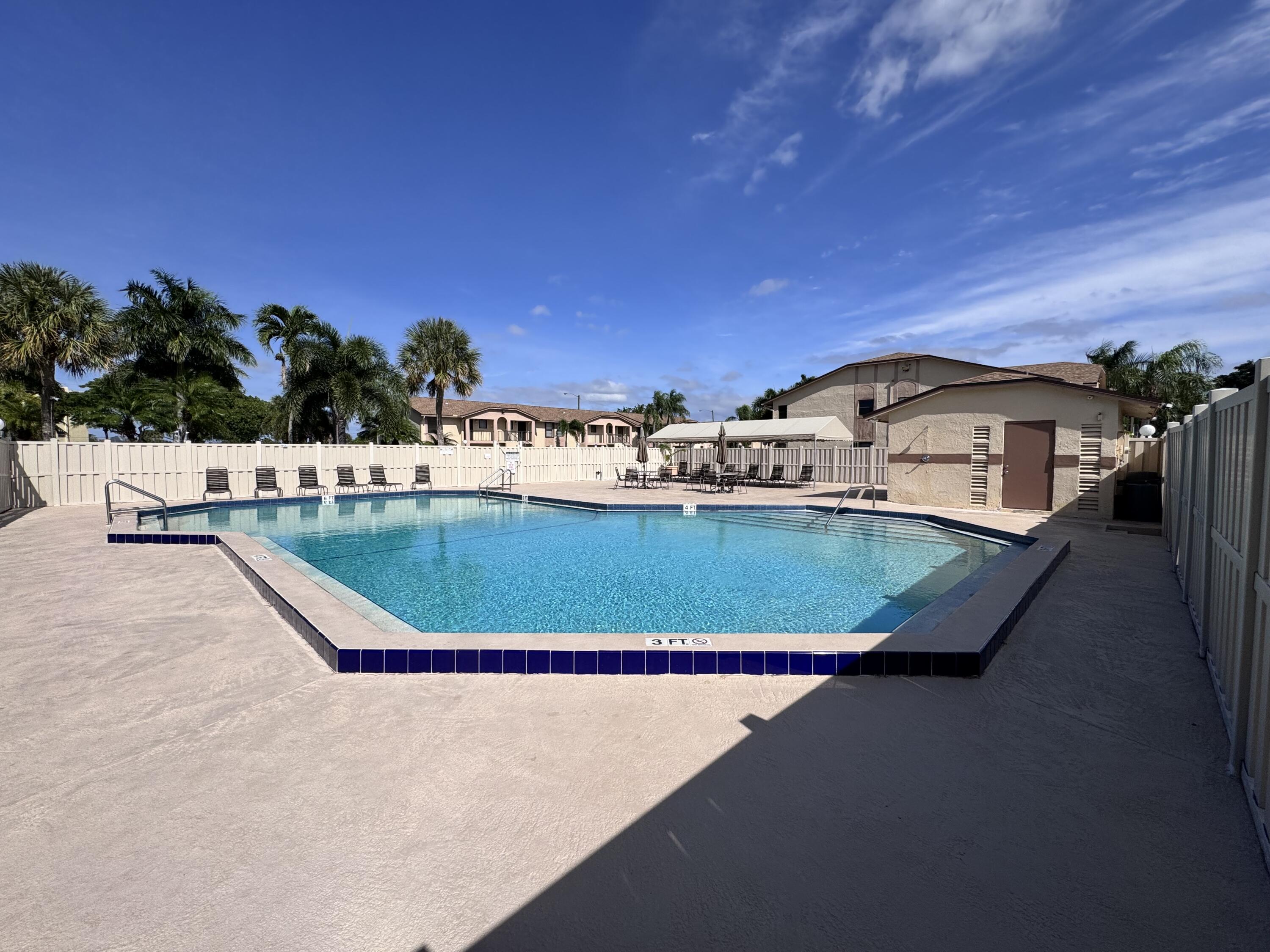 9503 Boca Cove Circle, Unit 602 Boca Raton, FL 33428 - Photo 24 of 24 a view of a swimming pool with a yard