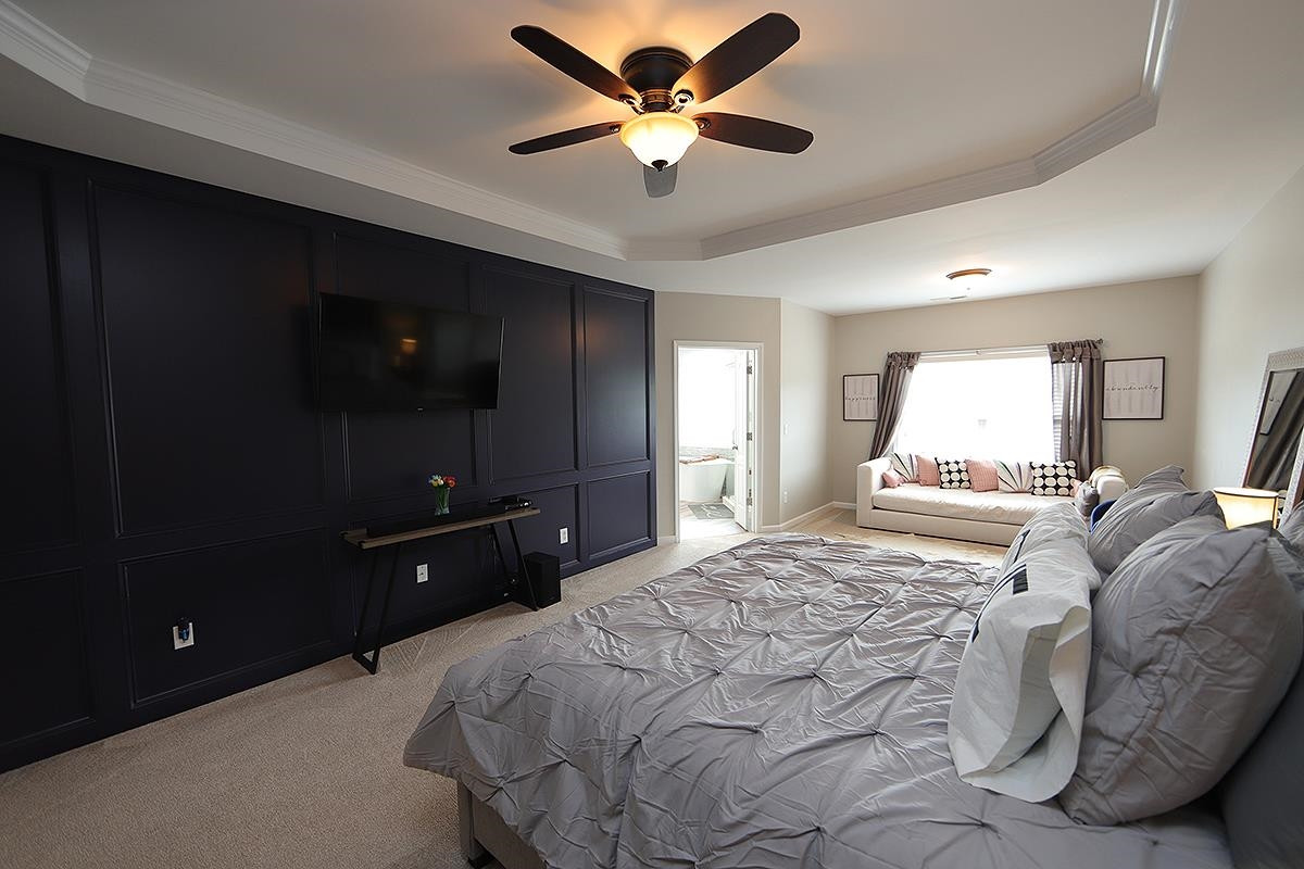 1105 Weston Green Loop Cary, NC 27513 - Photo 11 of 24 a bedroom with a bed and a chandelier