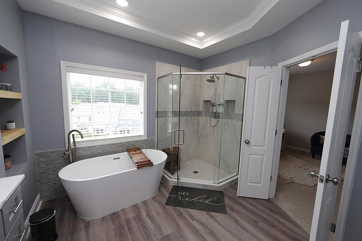 1105 Weston Green Loop Cary, NC 27513 - Photo 14 of 24 a bathroom with a sink a toilet a mirror and a tub