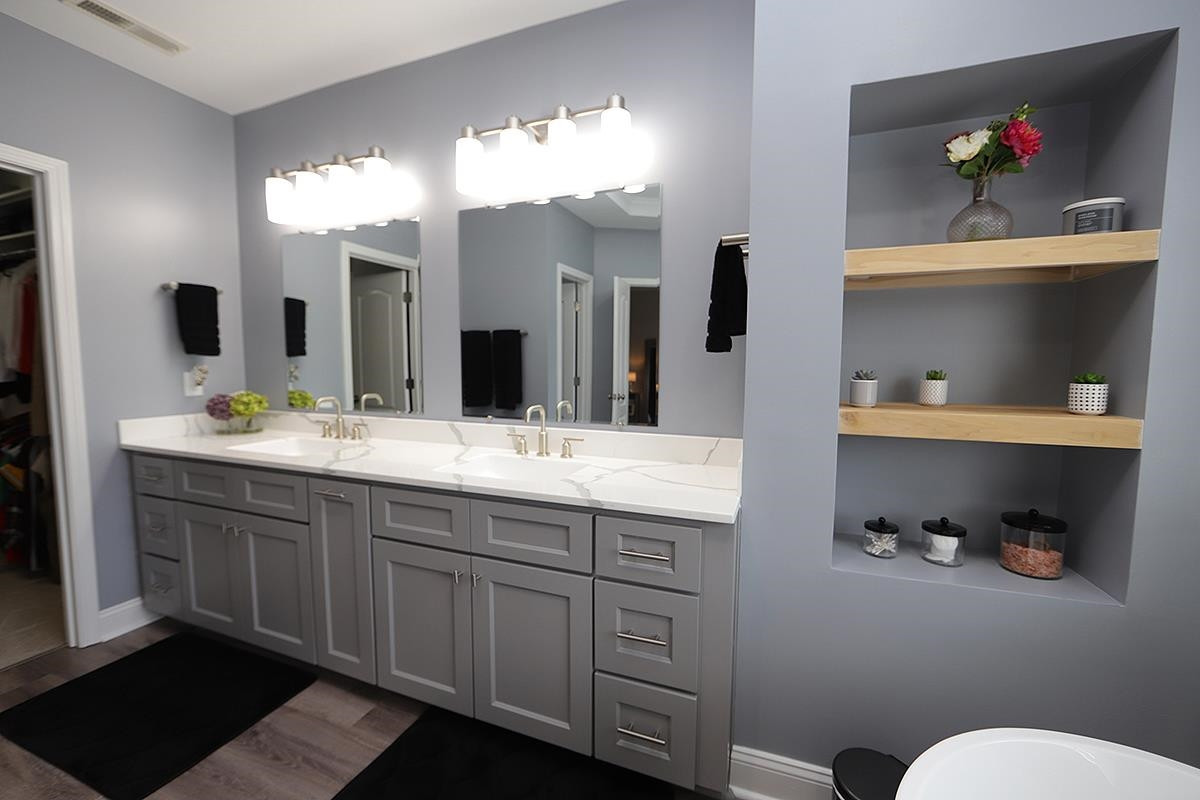 1105 Weston Green Loop Cary, NC 27513 - Photo 15 of 24 a bathroom with a double vanity sink and a toilet