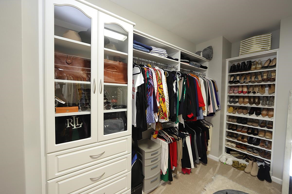 1105 Weston Green Loop Cary, NC 27513 - Photo 17 of 24 a view of walk in closet with clothes and shoes