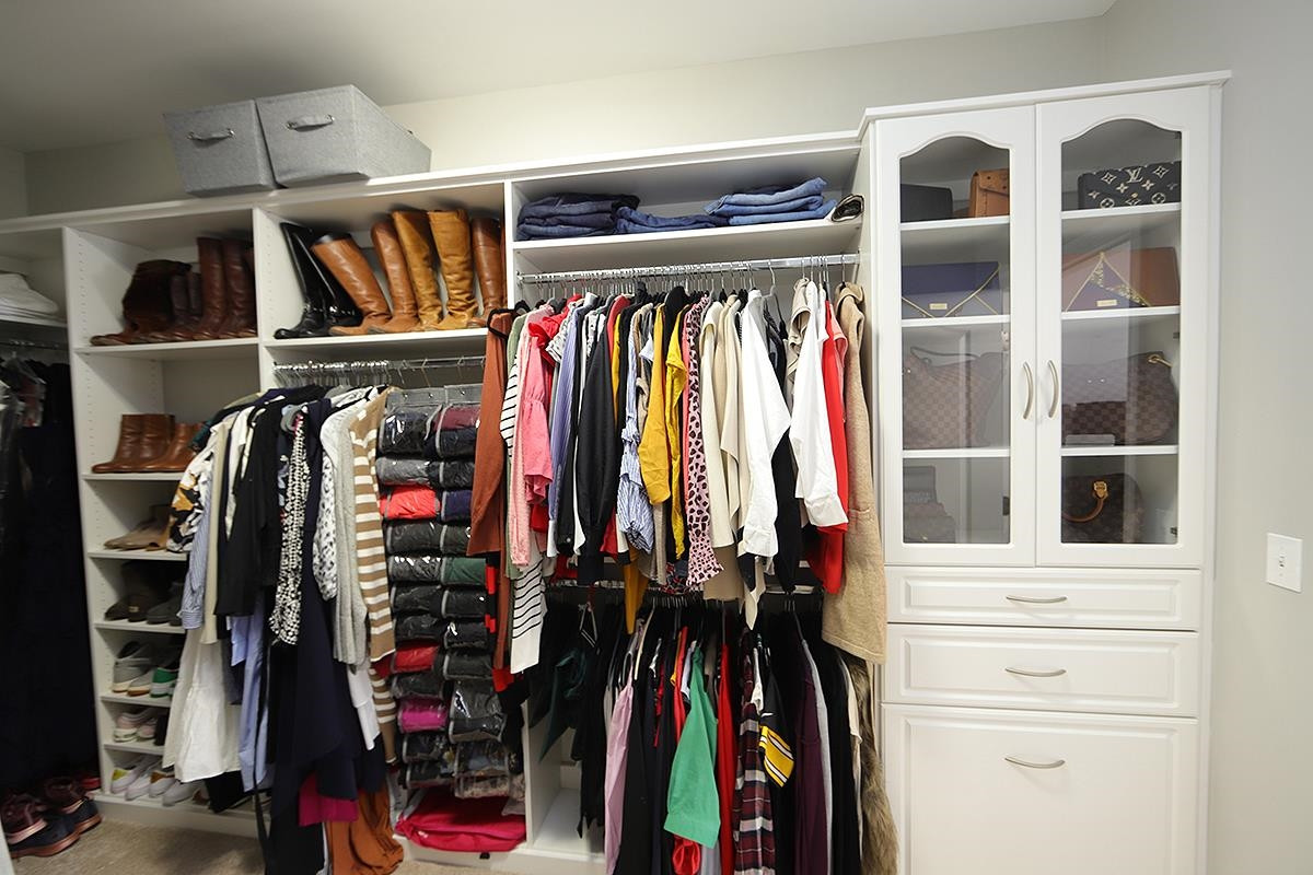 1105 Weston Green Loop Cary, NC 27513 - Photo 18 of 24 a view of walk in closet with clothes and shoes