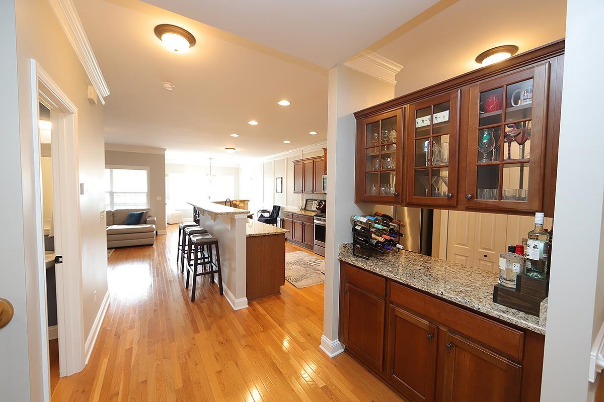 1105 Weston Green Loop Cary, NC 27513 - Photo 5 of 24 a kitchen with a table chairs refrigerator and a sink