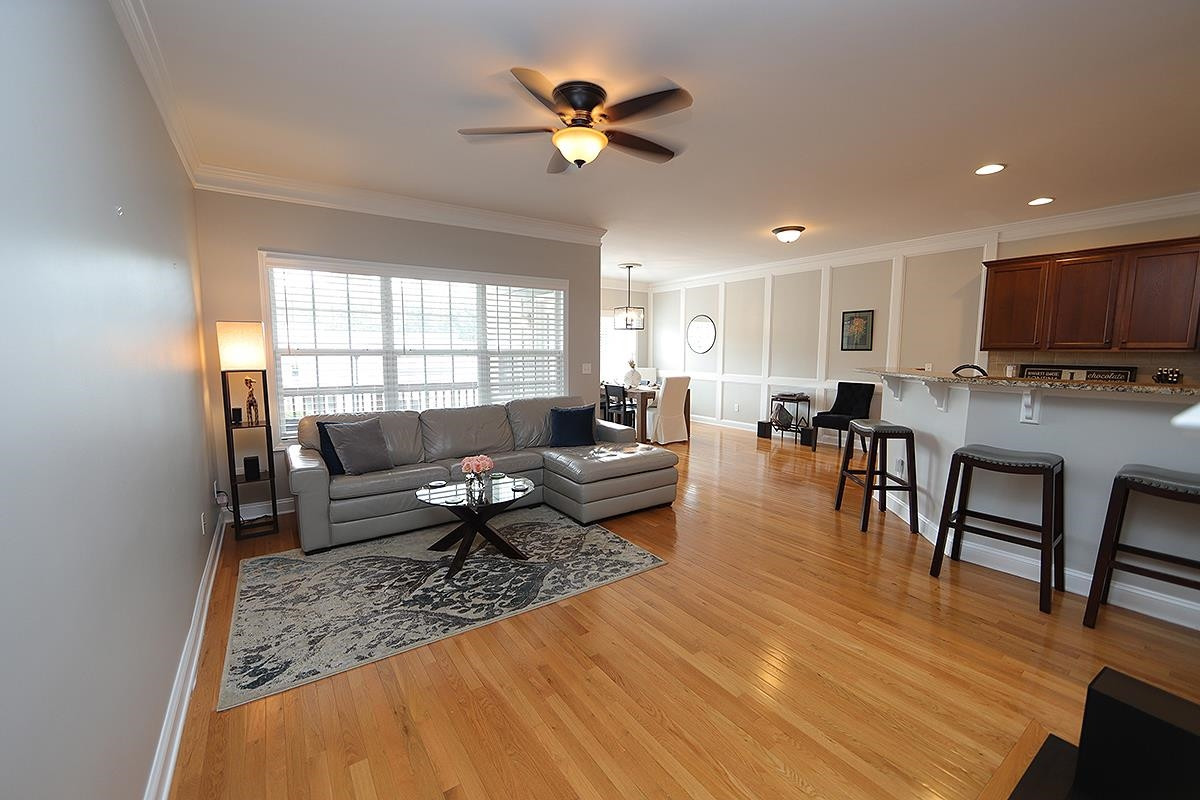 1105 Weston Green Loop Cary, NC 27513 - Photo 8 of 24 a living room with furniture and a wooden floor
