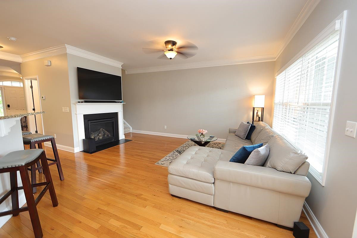 1105 Weston Green Loop Cary, NC 27513 - Photo 9 of 24 a living room with furniture fireplace and a flat screen tv