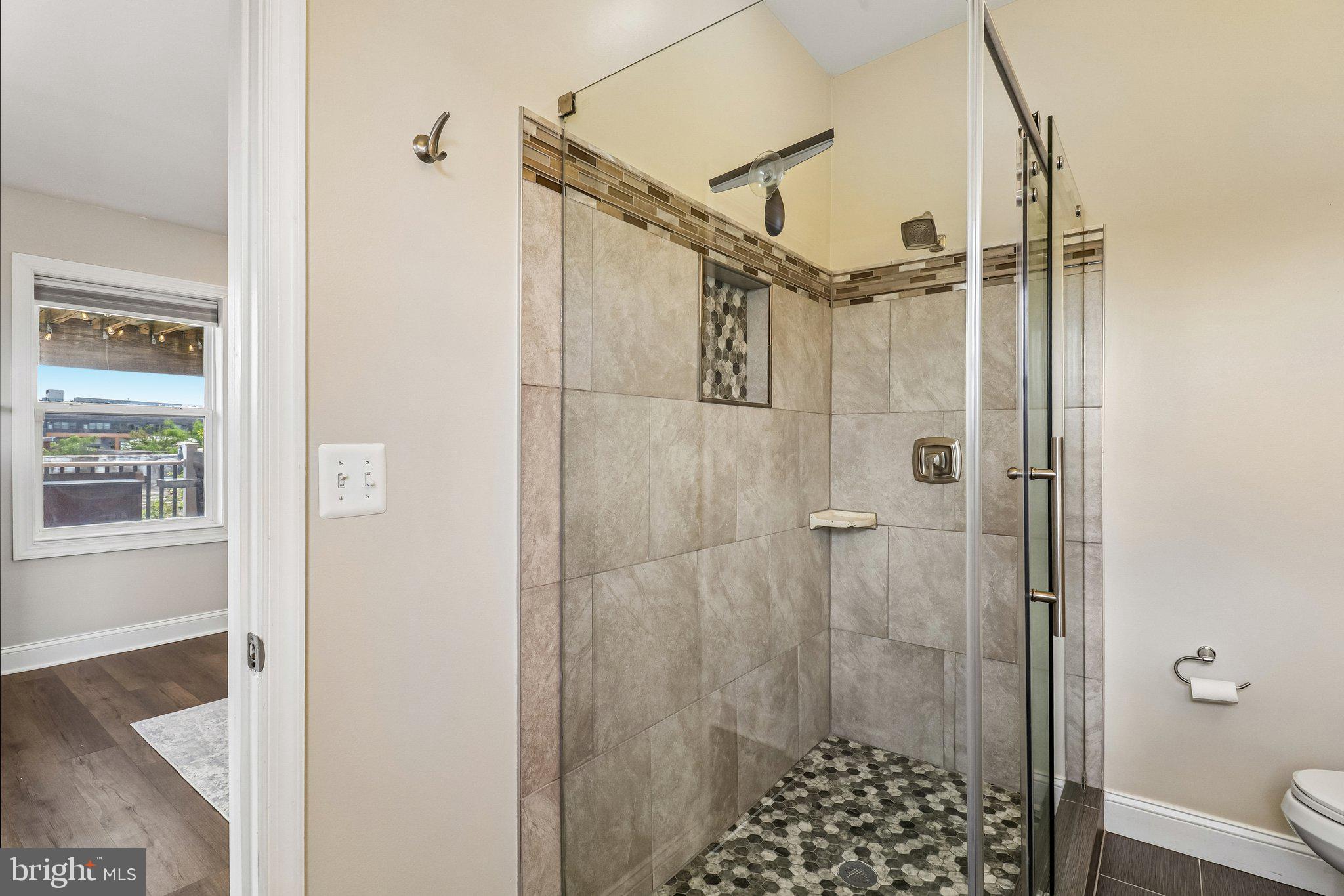 233 S Street Northeast, Unit 5 Washington, DC 20002 - Photo 32 of 41 Sleek modern shower with elegant tiles.