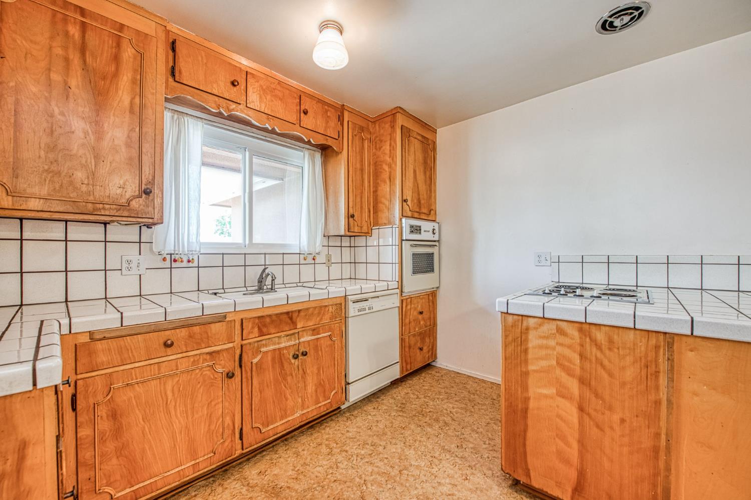 148 Russell Avenue Clovis, CA 93612 - Photo 11 of 33 a bathroom with a granite countertop sink and a mirror