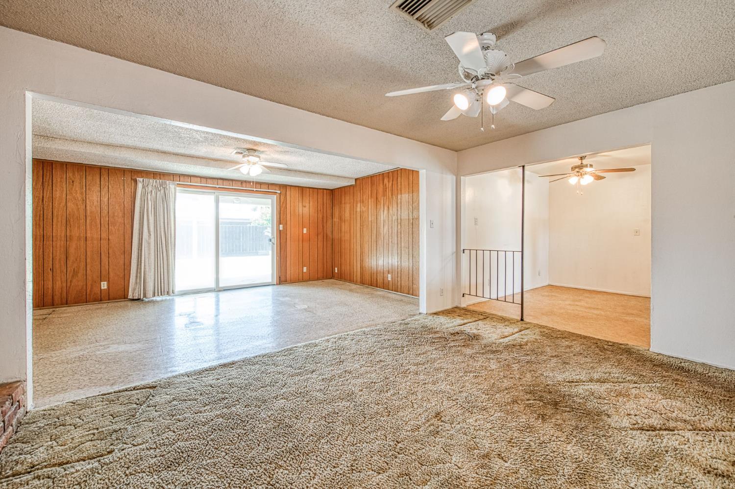 148 Russell Avenue Clovis, CA 93612 - Photo 14 of 33 a view of an empty room with window and chandelier fan