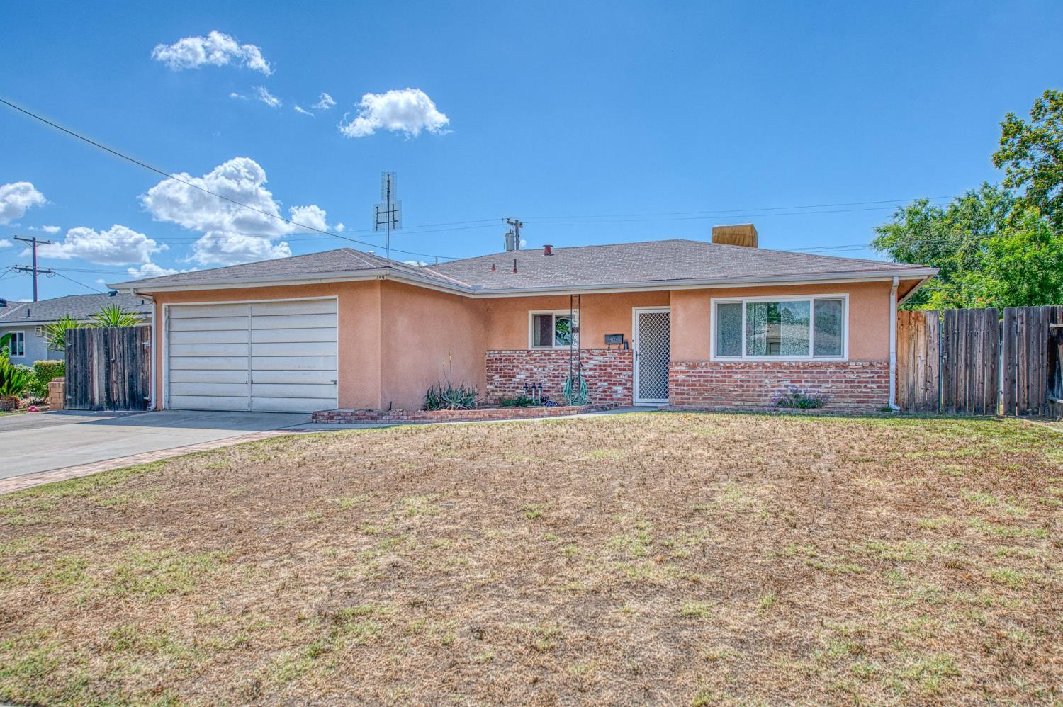 148 Russell Avenue Clovis, CA 93612 - Photo 2 of 33 a front view of a house with a yard and garage