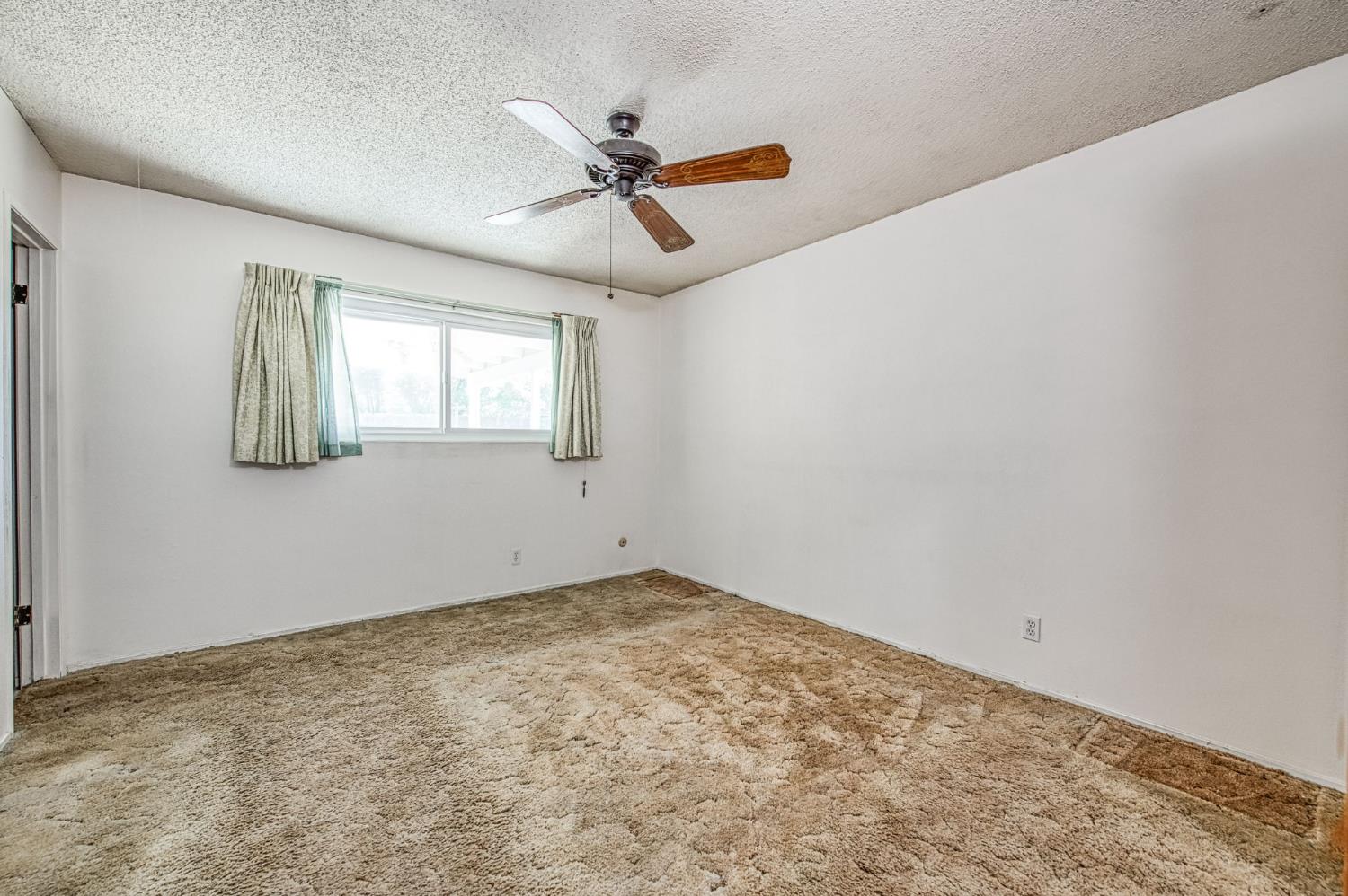 148 Russell Avenue Clovis, CA 93612 - Photo 23 of 33 an empty room with windows and fan
