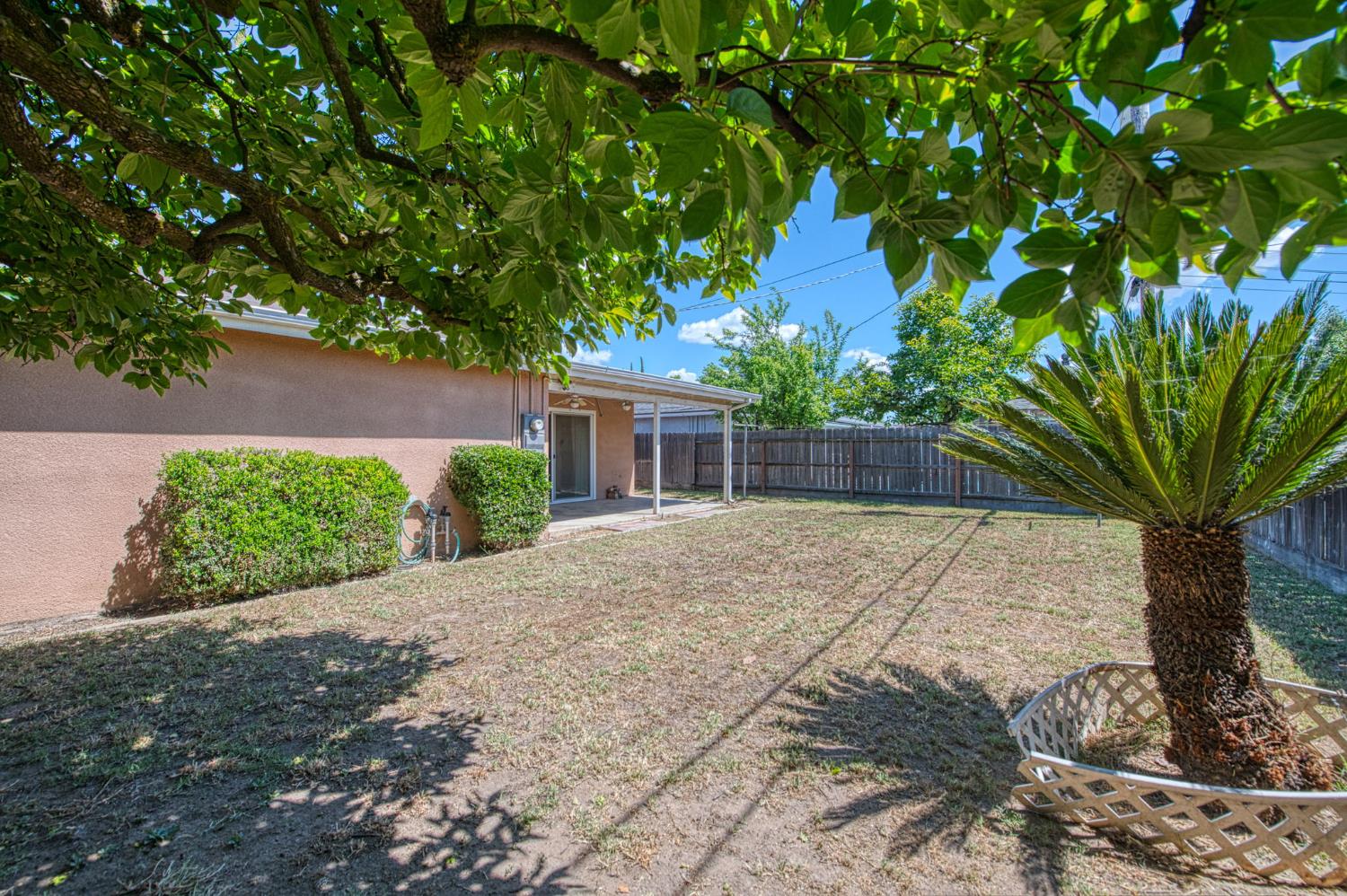 148 Russell Avenue Clovis, CA 93612 - Photo 33 of 33 a front view of a house with a yard and a garage