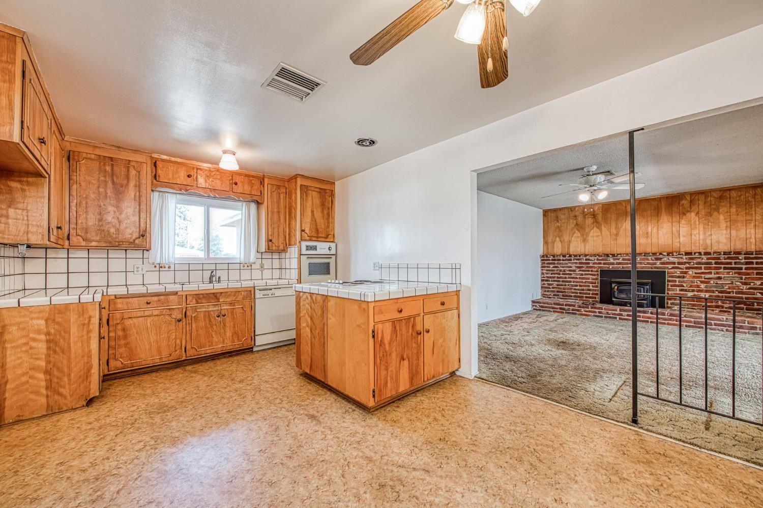148 Russell Avenue Clovis, CA 93612 - Photo 9 of 33 a large kitchen with granite countertop a sink and white cabinets