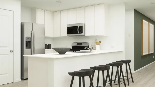 a kitchen with stainless steel appliances a microwave a sink and white cabinets