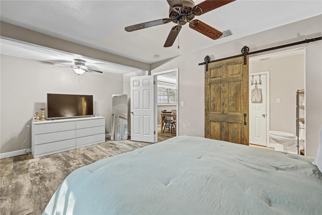 708 East Main Street Sinton, TX 78387 - Photo 11 of 28 a bedroom with a bed and a flat screen tv