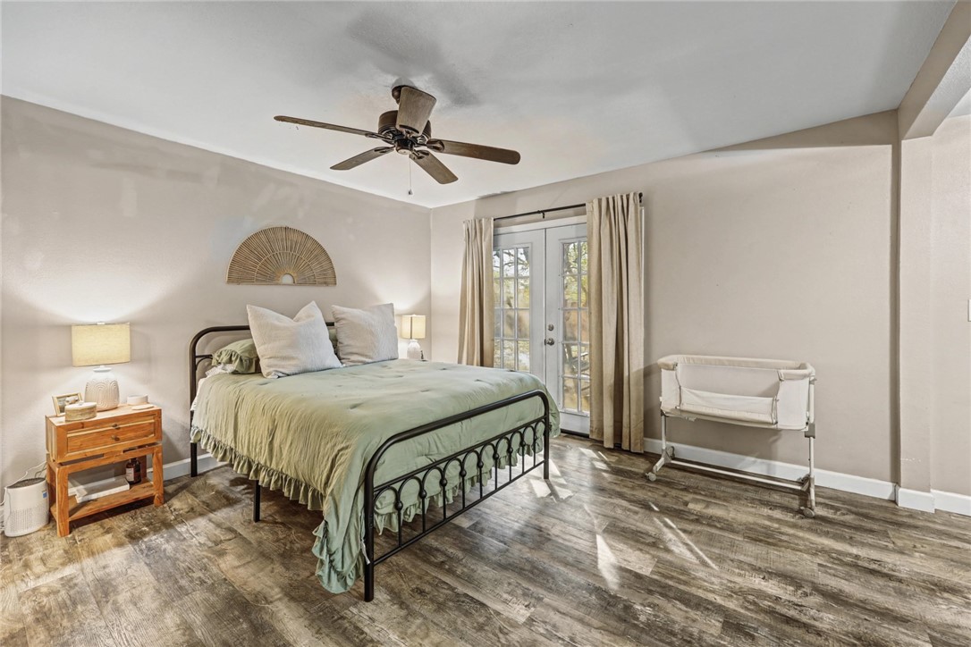 708 East Main Street Sinton, TX 78387 - Photo 13 of 28 a bedroom with a bed and a chandelier