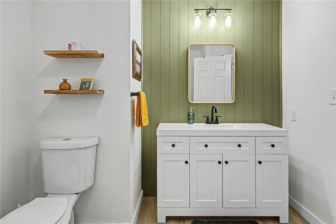 708 East Main Street Sinton, TX 78387 - Photo 21 of 28 a bathroom with a sink a toilet and mirror