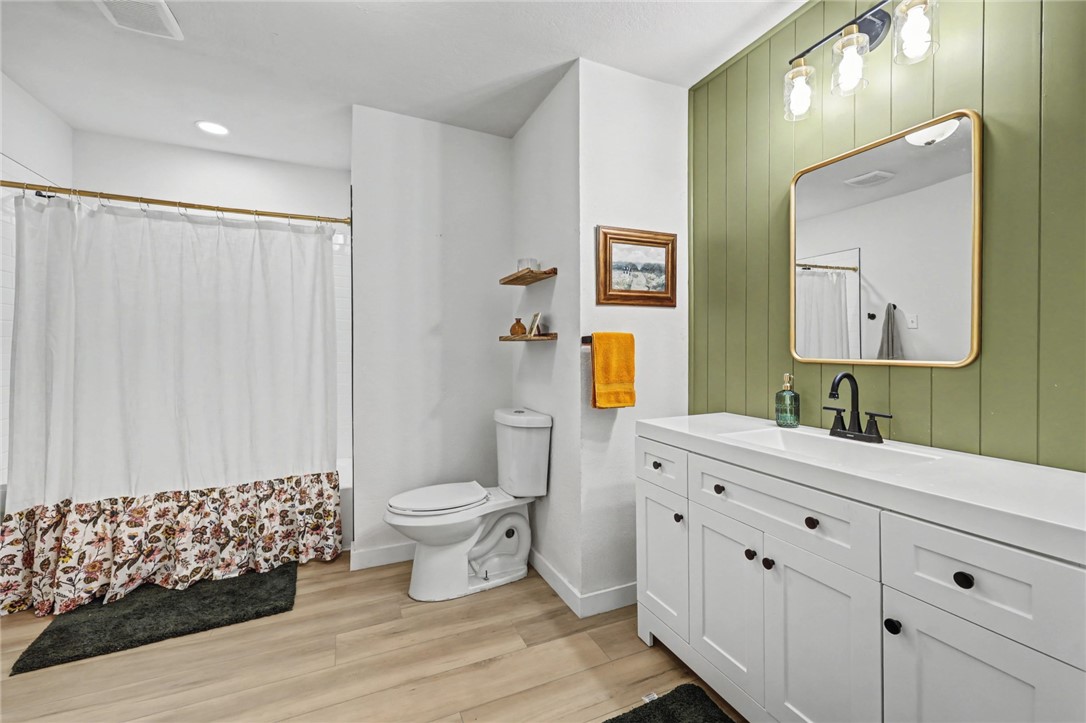 708 East Main Street Sinton, TX 78387 - Photo 22 of 28 a bathroom with a double vanity sink mirror and toilet