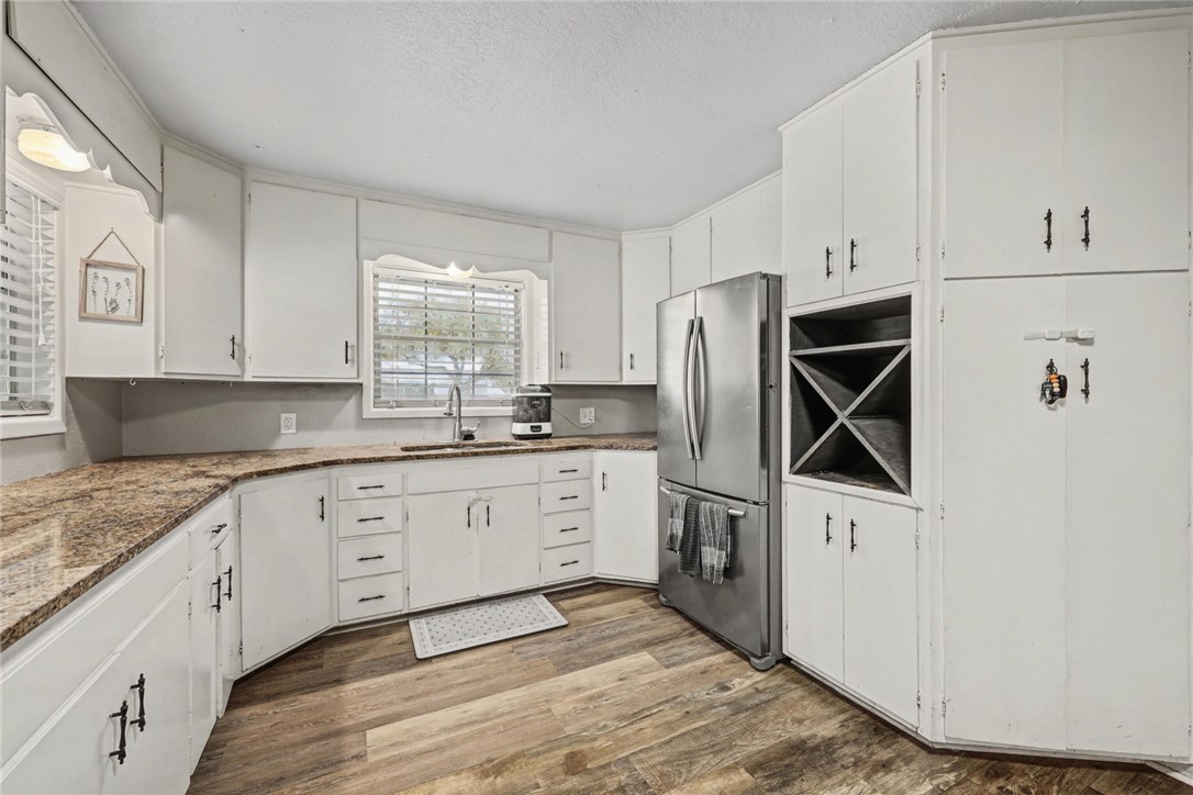 708 East Main Street Sinton, TX 78387 - Photo 5 of 28 a kitchen with stainless steel appliances granite countertop a stove a sink and a refrigerator