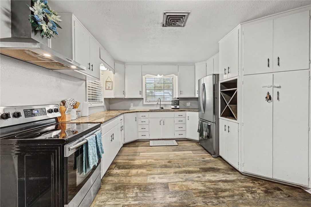 708 East Main Street Sinton, TX 78387 - Photo 6 of 28 a kitchen with stainless steel appliances a refrigerator sink and cabinets