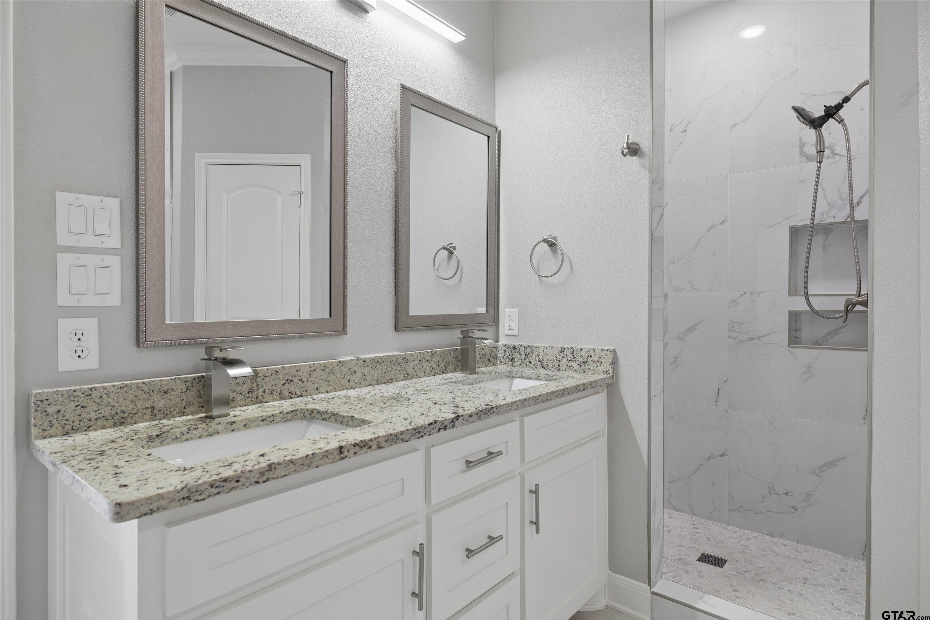 629 Third Street Bullard, TX 75757 - Photo 14 of 18 a bathroom with a granite countertop sink two mirror and shower