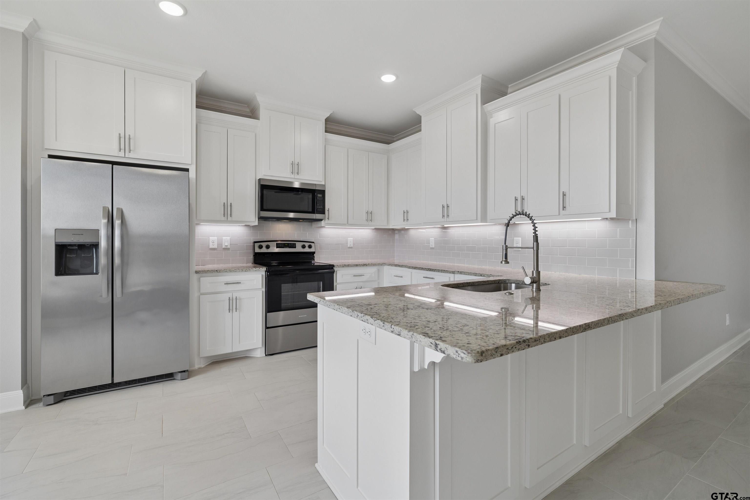 629 Third Street Bullard, TX 75757 - Photo 4 of 18 a kitchen with a refrigerator sink and cabinets