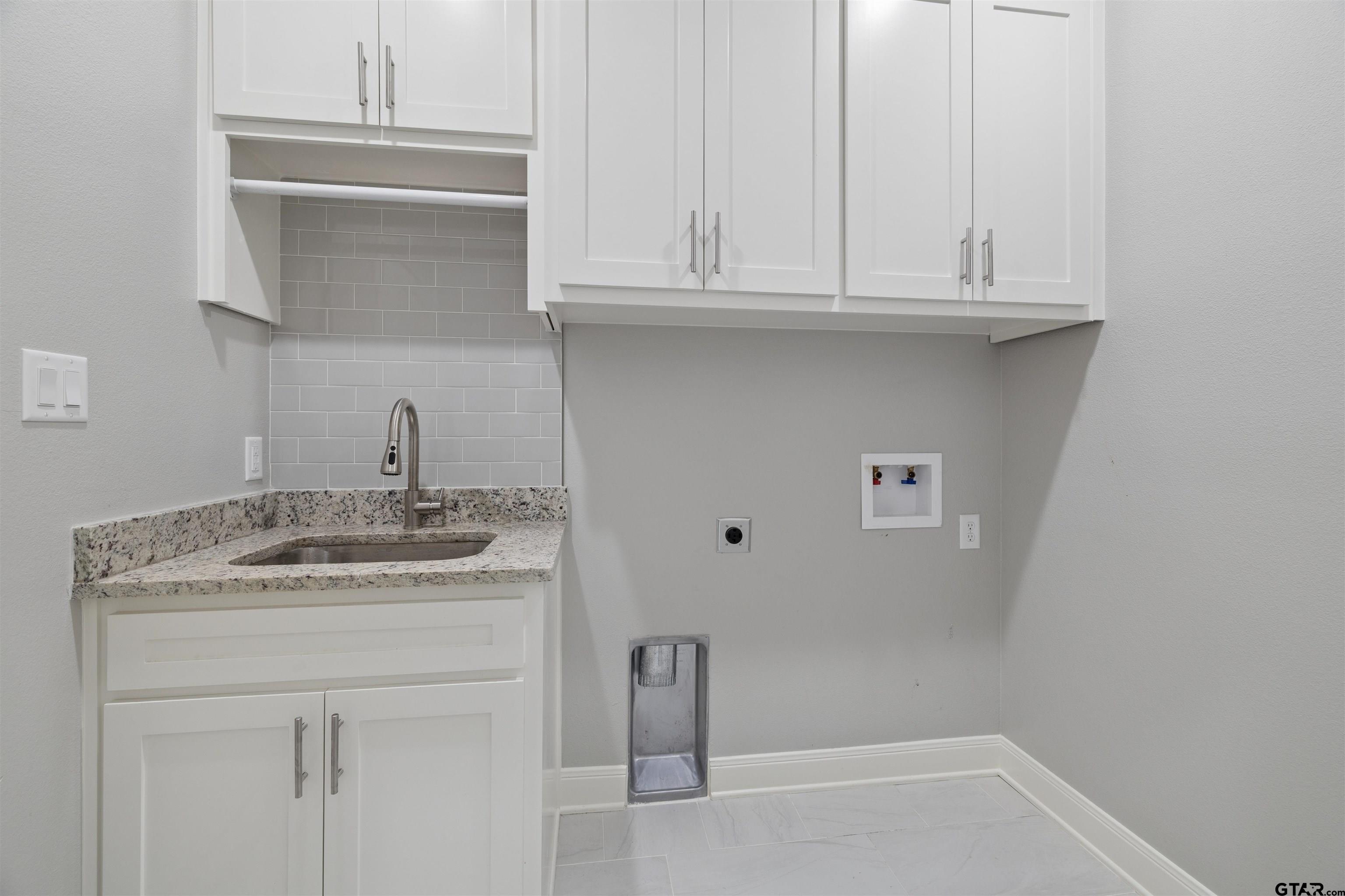 629 Third Street Bullard, TX 75757 - Photo 10 of 18 a bathroom with a sink and cabinets