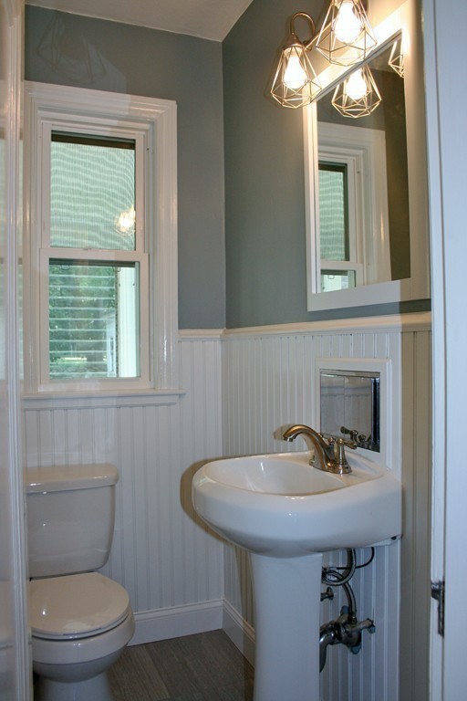 19 Dellwood Road Worcester, MA 01602 - Photo 11 of 26 a bathroom with a toilet a sink and mirror