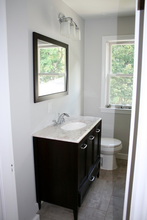 19 Dellwood Road Worcester, MA 01602 - Photo 12 of 26 a bathroom with a double vanity sink toilet and a window