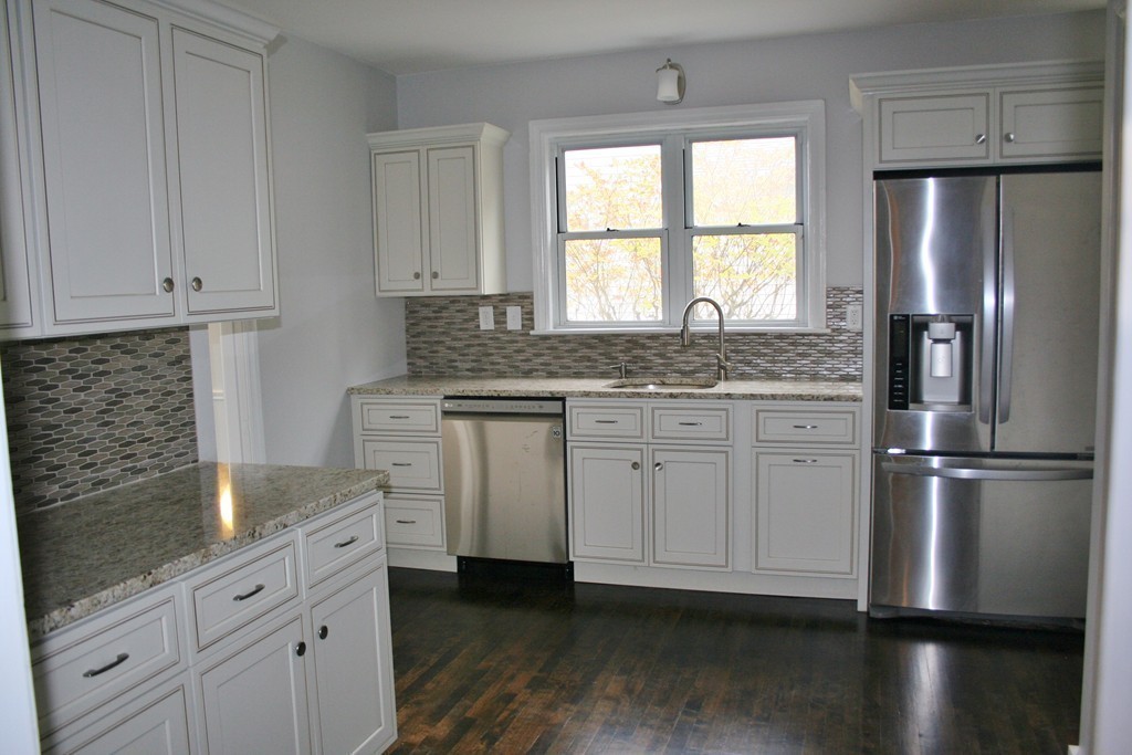 19 Dellwood Road Worcester, MA 01602 - Photo 2 of 26 a kitchen with granite countertop stainless steel appliances a refrigerator sink and cabinets
