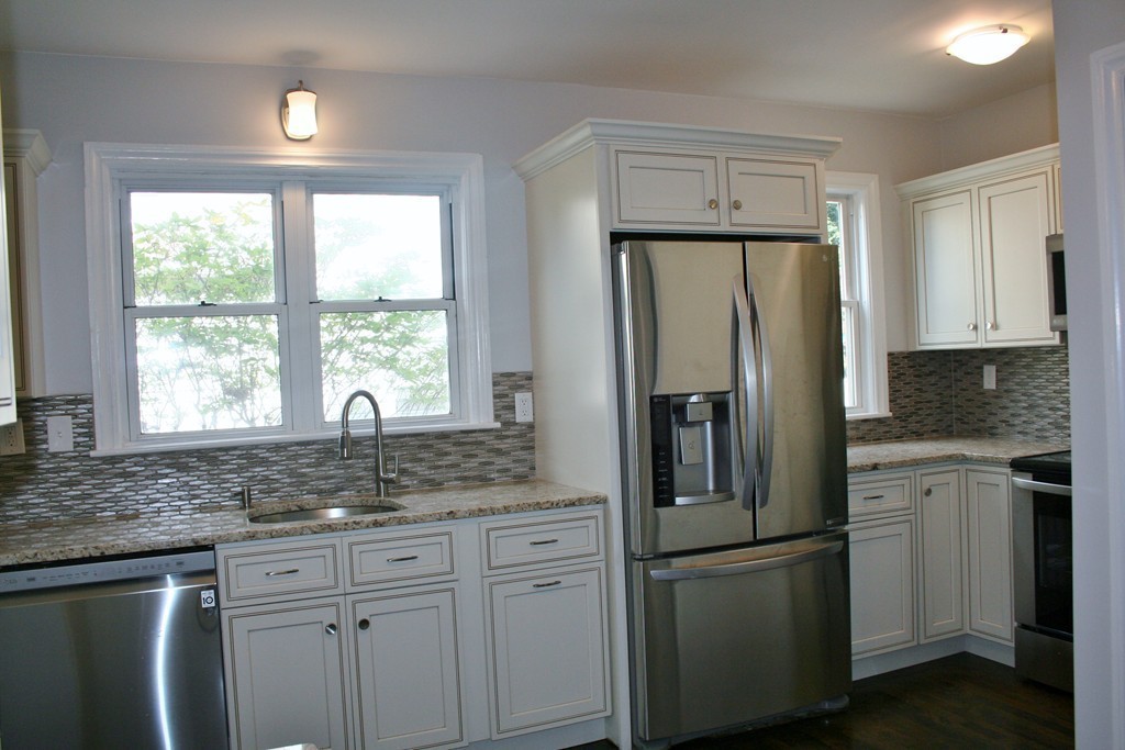 19 Dellwood Road Worcester, MA 01602 - Photo 22 of 26 a kitchen with stainless steel appliances granite countertop a refrigerator sink and cabinets