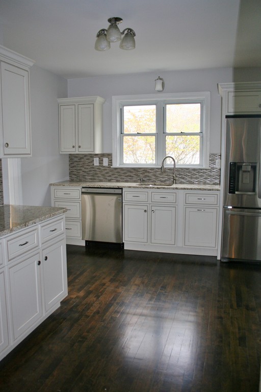 19 Dellwood Road Worcester, MA 01602 - Photo 8 of 26 a large kitchen with a large window a sink and stainless steel appliances