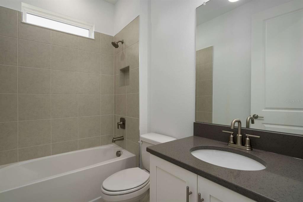 318 Rafael Boulevard Northeast St. Petersburg, FL 33704 - Photo 16 of 38 a bathroom with a granite countertop sink toilet and shower