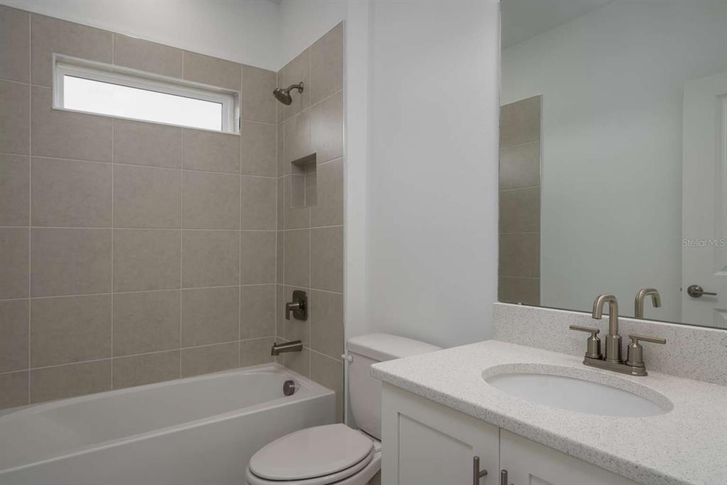 318 Rafael Boulevard Northeast St. Petersburg, FL 33704 - Photo 20 of 38 a bathroom with a granite countertop sink toilet and shower
