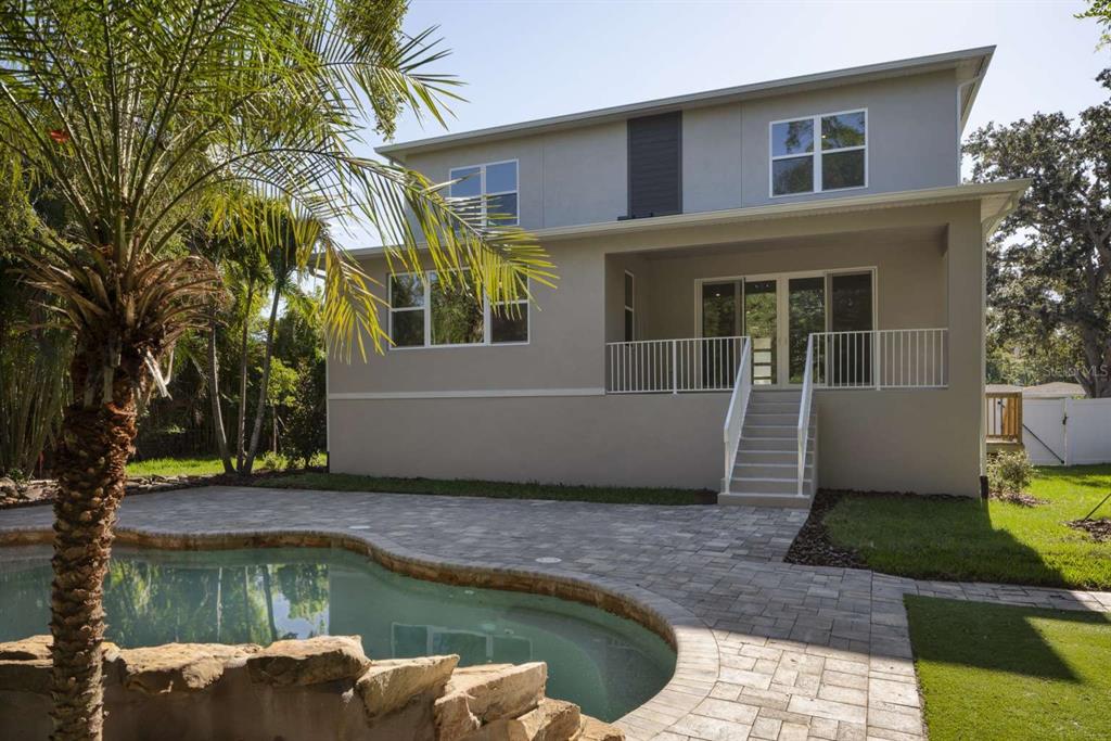 318 Rafael Boulevard Northeast St. Petersburg, FL 33704 - Photo 35 of 38 a view of a house with pool and sitting area