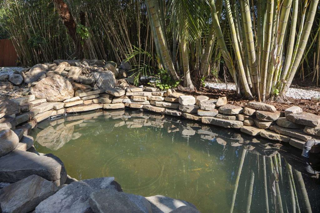 318 Rafael Boulevard Northeast St. Petersburg, FL 33704 - Photo 38 of 38 a view of swimming pool with a garden and trees