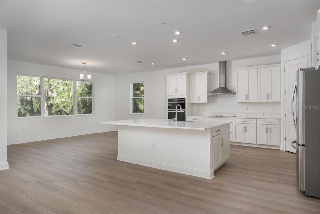 318 Rafael Boulevard Northeast St. Petersburg, FL 33704 - Photo 7 of 38 a kitchen with stainless steel appliances a white stove top oven cabinets and a refrigerator