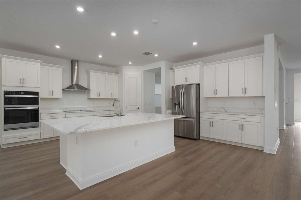318 Rafael Boulevard Northeast St. Petersburg, FL 33704 - Photo 8 of 38 a large kitchen with stainless steel appliances and white cabinets