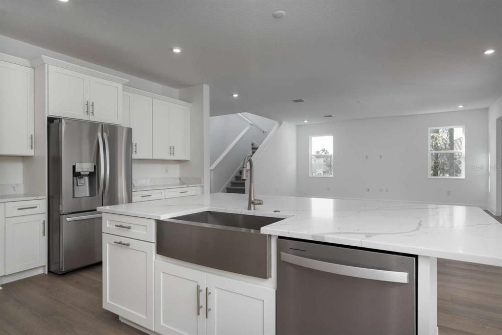 318 Rafael Boulevard Northeast St. Petersburg, FL 33704 - Photo 10 of 38 a kitchen with a sink a stove a refrigerator and white cabinets