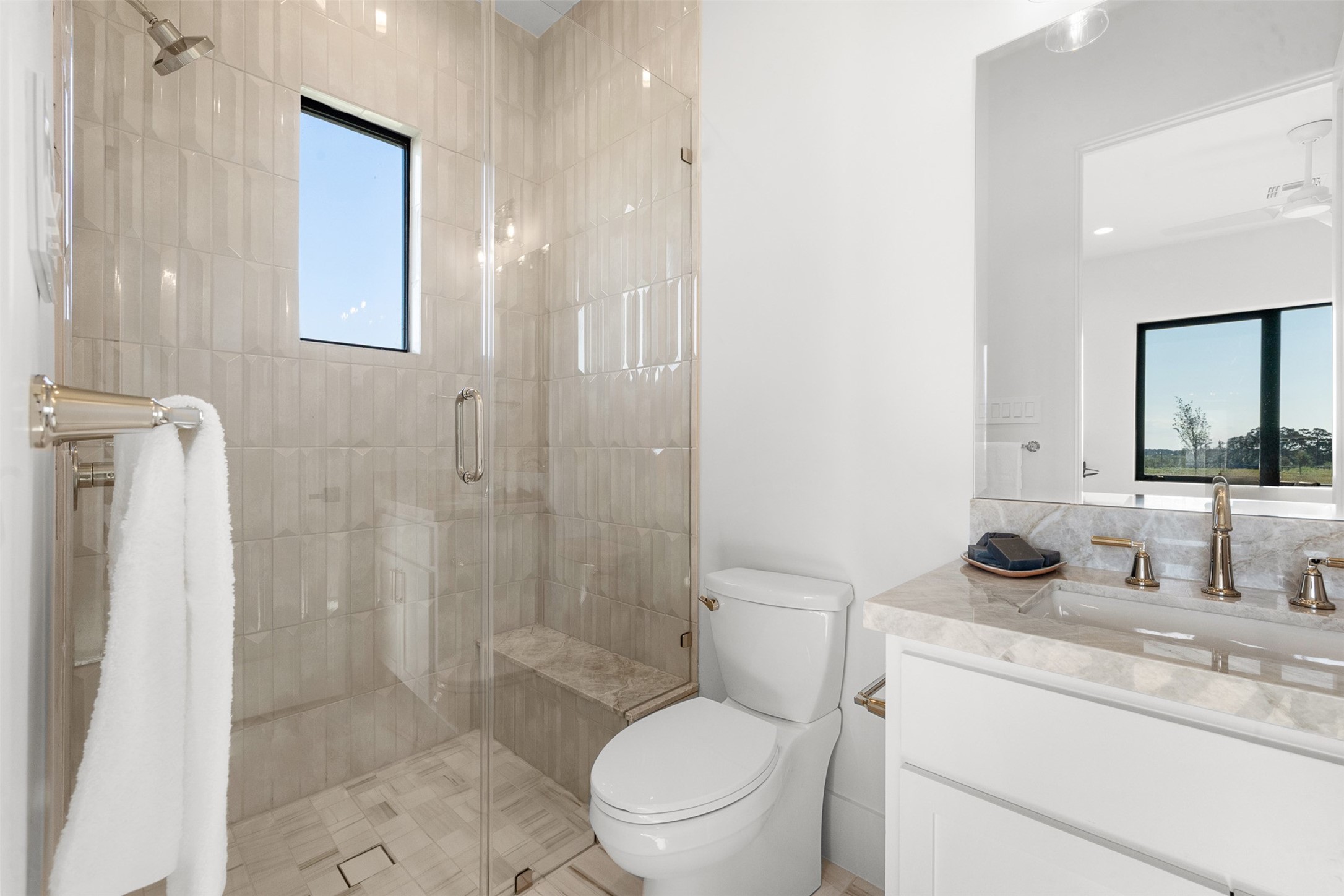 4961 Hartfield Road Round Top, TX 78954 - Photo 14 of 22 a bathroom with a granite countertop toilet a sink and a mirror