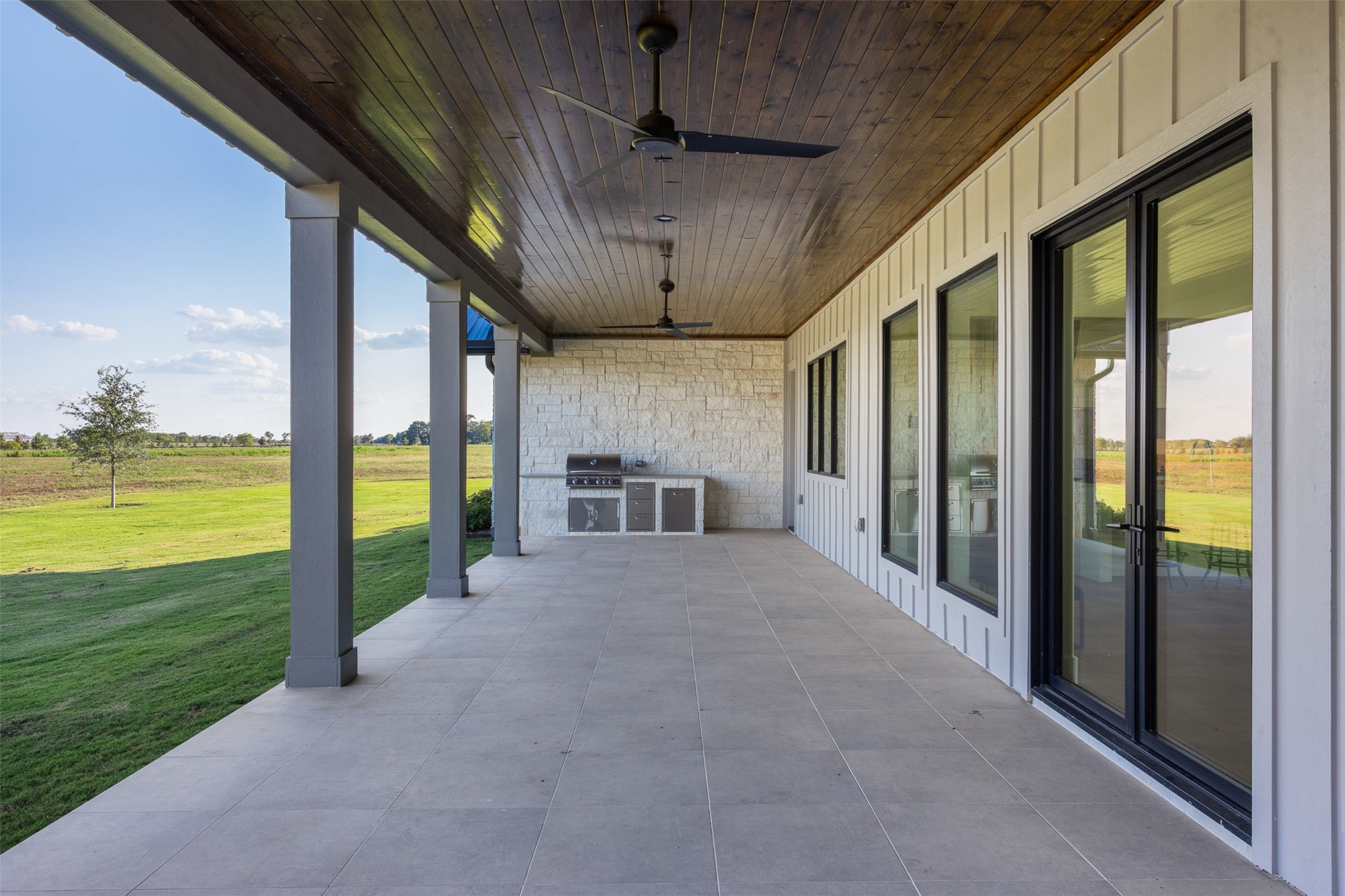 4961 Hartfield Road Round Top, TX 78954 - Photo 18 of 22 a view of a porch with furniture and floor to ceiling window