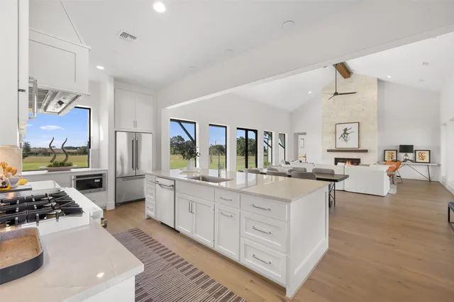 a large white kitchen with lots of counter top space