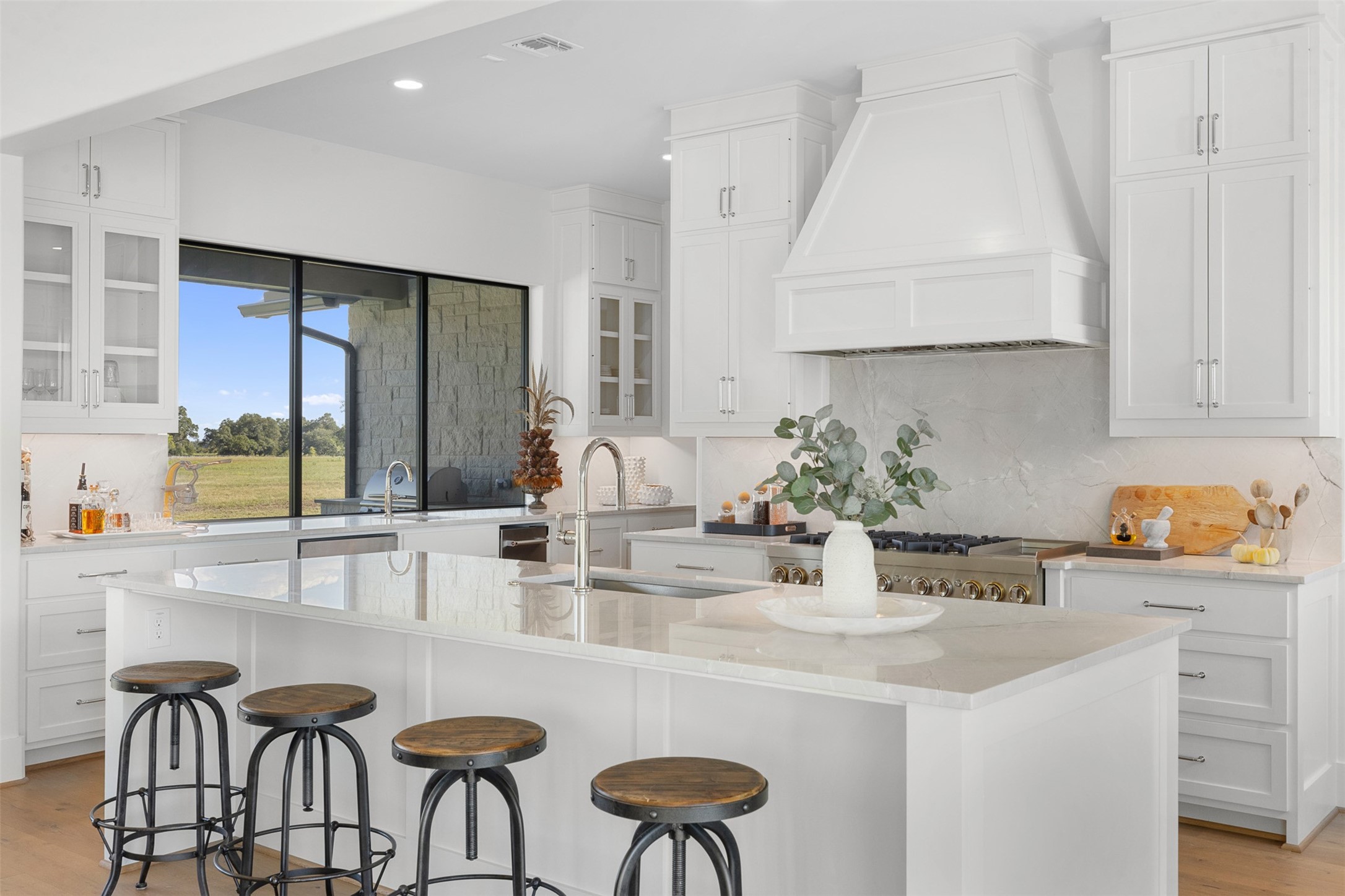 4961 Hartfield Road Round Top, TX 78954 - Photo 5 of 22 a kitchen with granite countertop a table chairs stove and cabinets