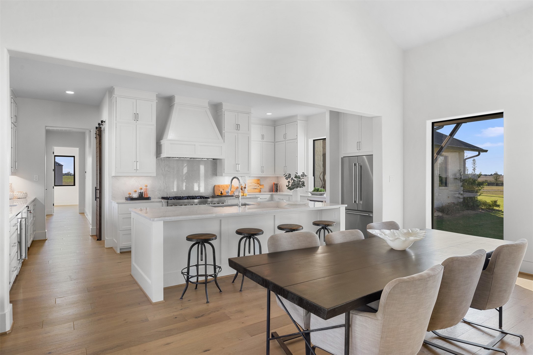 4961 Hartfield Road Round Top, TX 78954 - Photo 6 of 22 a kitchen with granite countertop white cabinets and stainless steel appliances