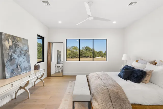 a bedroom with a large bed and a large window