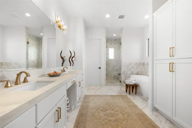 a spacious bathroom with a double vanity sink mirror and shower